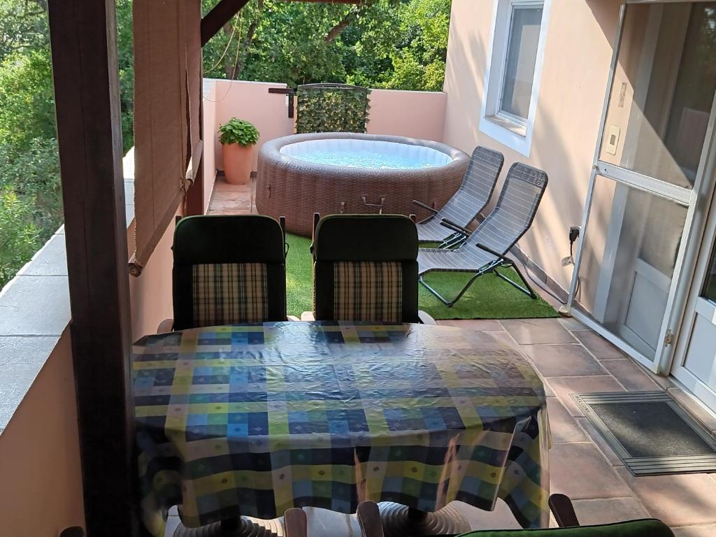 a patio with a table and chairs and a pool at Apartment Simona - Extra comfort with large terrace and jacuzzi in Barbariga