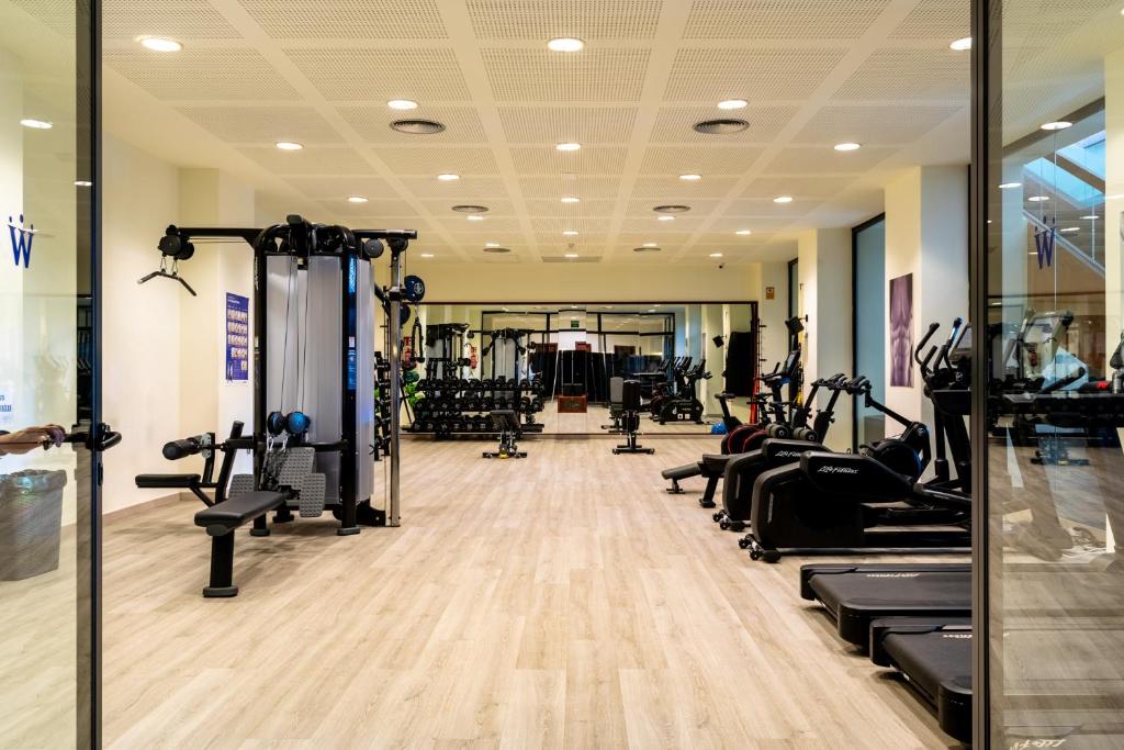 a gym with treadmills and elliptical machines at Puerto Antilla Grand Hotel in Islantilla