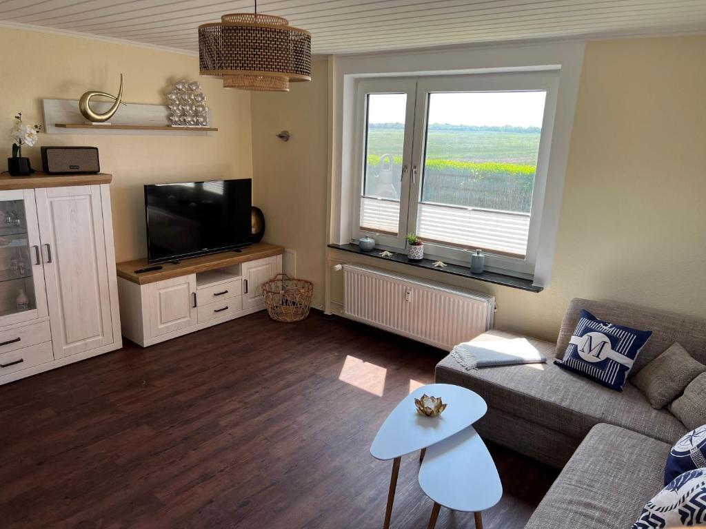 a living room with a couch and a tv at Fischerbalje Bantje Wohnung 1 in Borkum