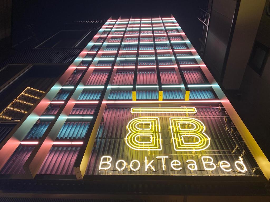 a building with a sign on the side of it at Book Tea Bed SHIBUYA in Tokyo