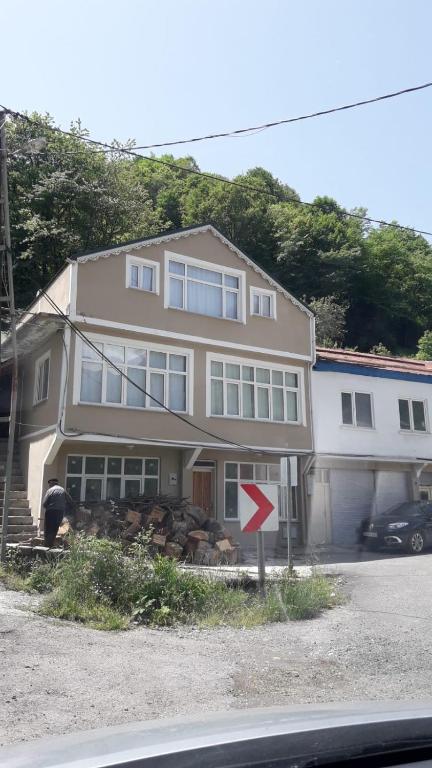 a house with a man standing in front of it at KESKİN günü birlik konut in Macka