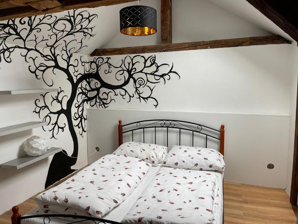 A bed or beds in a room at Apartmány Laverna