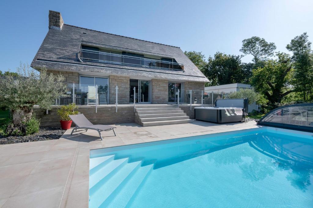 a house with a swimming pool in front of a house at Deconnexion et detente sur la Presqu ile de Rhuys in Le Tour-du-Parc