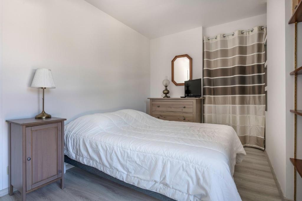 a bedroom with a bed and a dresser and a mirror at Deconnexion et detente sur la Presqu ile de Rhuys in Le Tour-du-Parc