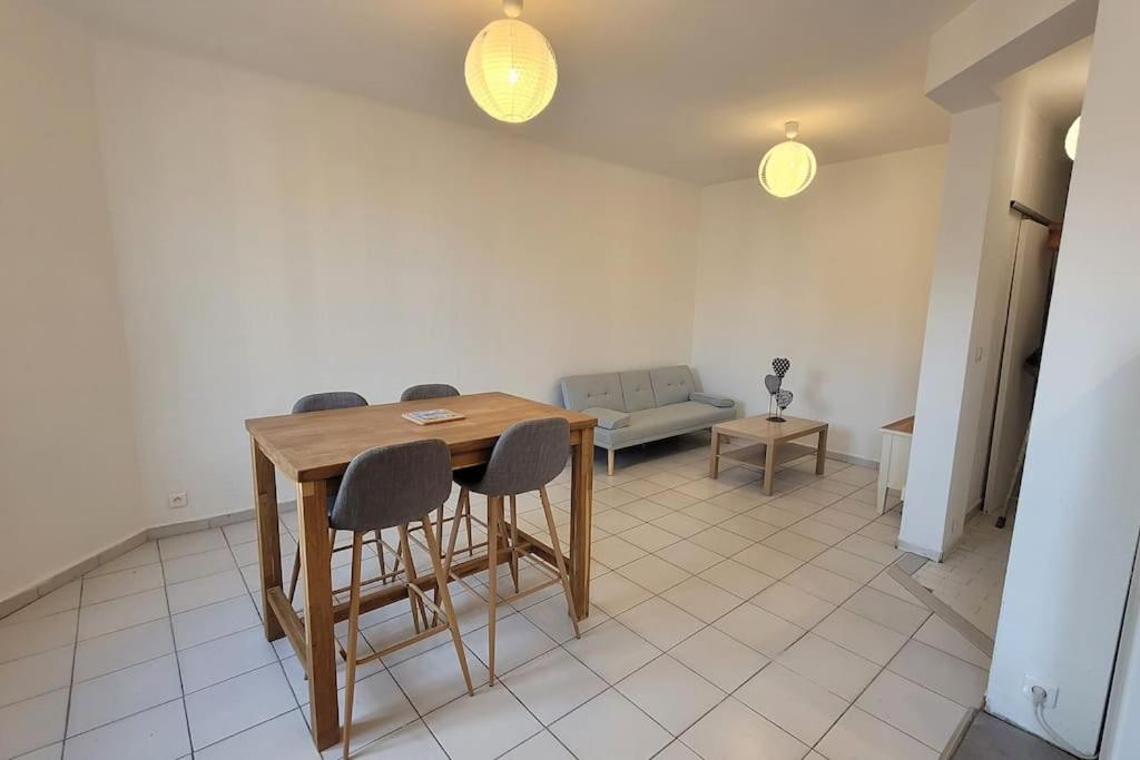 a room with a table and chairs and a couch at Appartement Toulon 5/6 couchages in Toulon