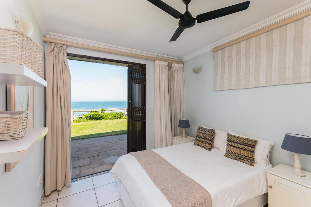 a bedroom with a bed and a view of the ocean at Boulder Bay 9 in Ballito