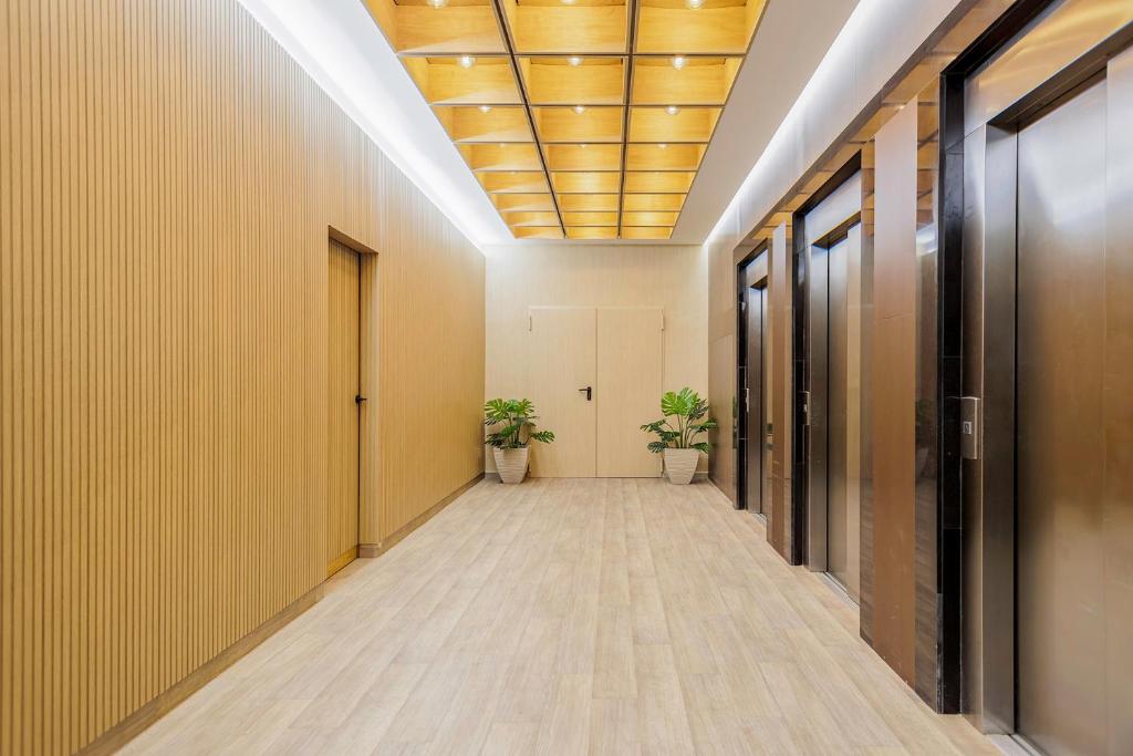 an office corridor with yellow walls and a ceiling at Cullera Holiday in Cullera