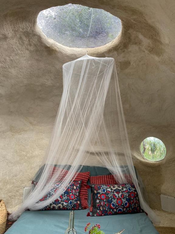a bedroom with a bed with a mosquito net at La lodge vue mer in Nice