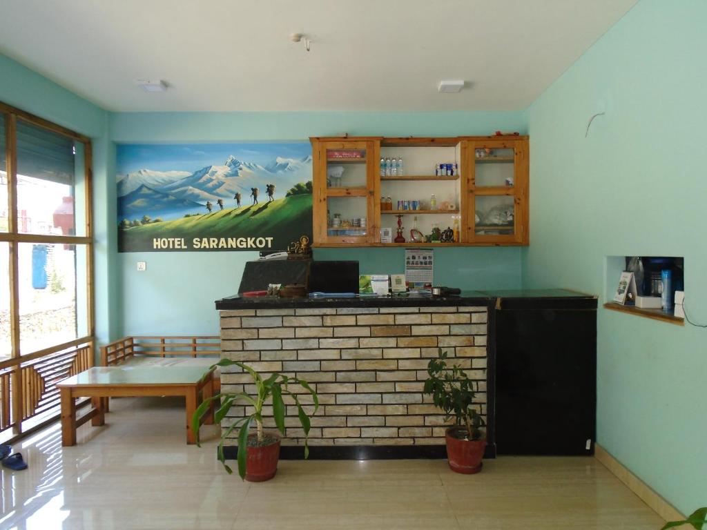 a bar in a restaurant with a mural on the wall at Hotel Sarangkot in Pokhara