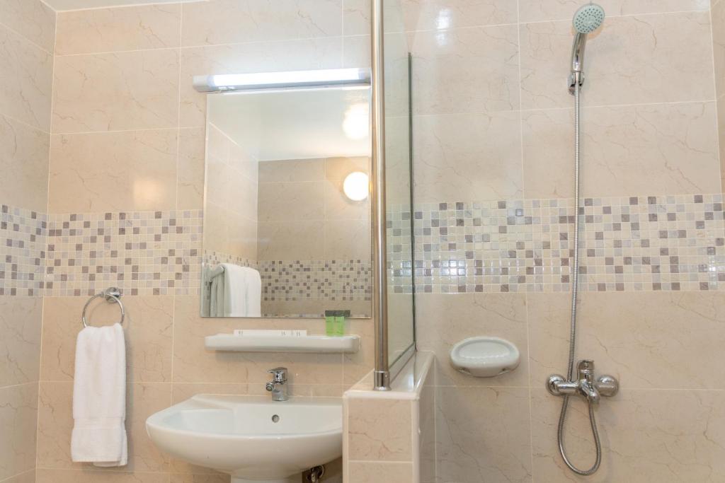 a bathroom with a sink and a shower at Fujairah Hotel & Resort in Fujairah