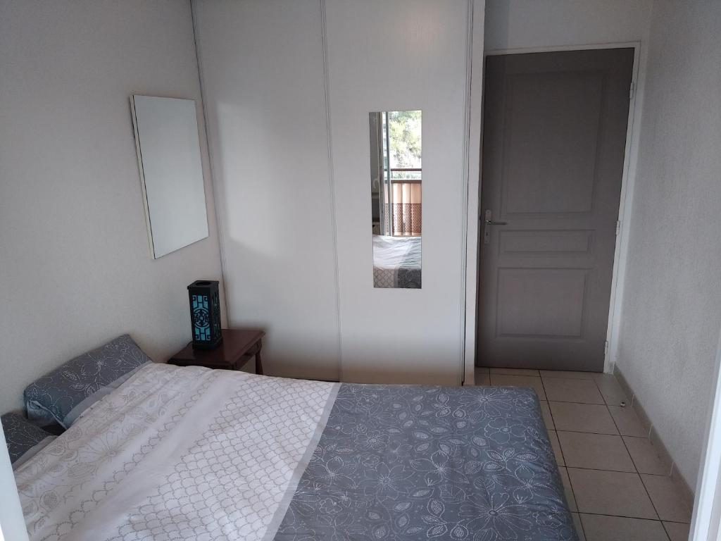 a bedroom with a bed and a door leading to a hallway at Rêve d une nuit d été in Aubagne