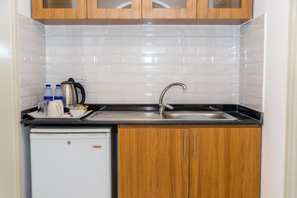a kitchen with a sink and a counter top at Fujairah Hotel & Resort in Fujairah