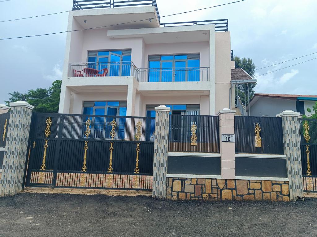 a house with a gate in front of it at Puma Aparthotel - Nyarutarama in Kigali
