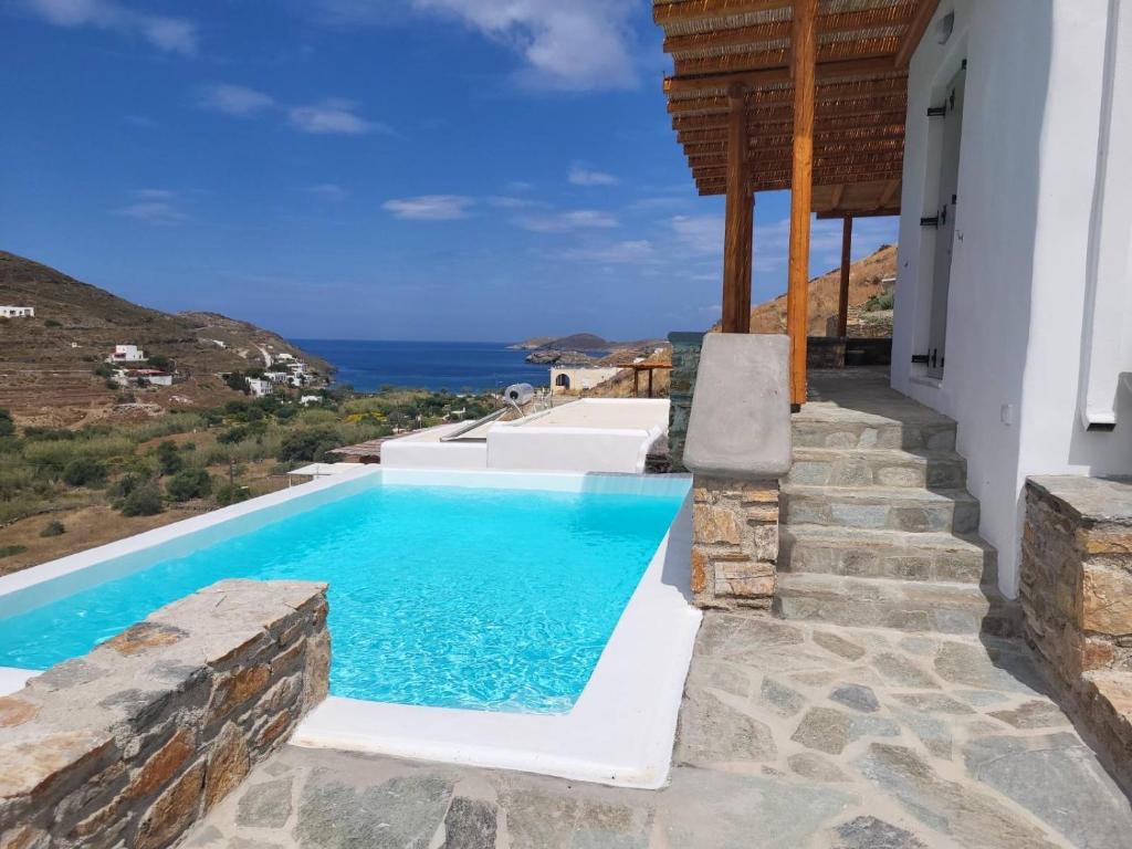 a pool with a view of the ocean from a house at Epithea Suites Kythnos 3 με ιδιωτική πισίνα in Kithnos