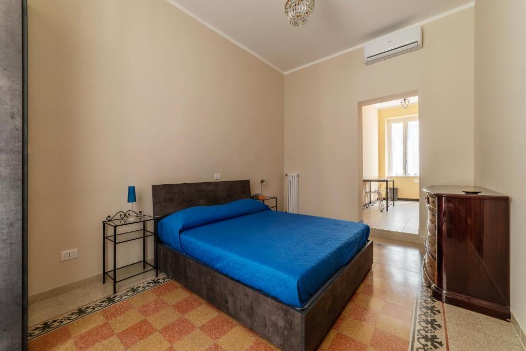 ein Schlafzimmer mit einem Bett mit einer blauen Decke in der Unterkunft Functional Apartment - Piazza Re di Roma in Rom