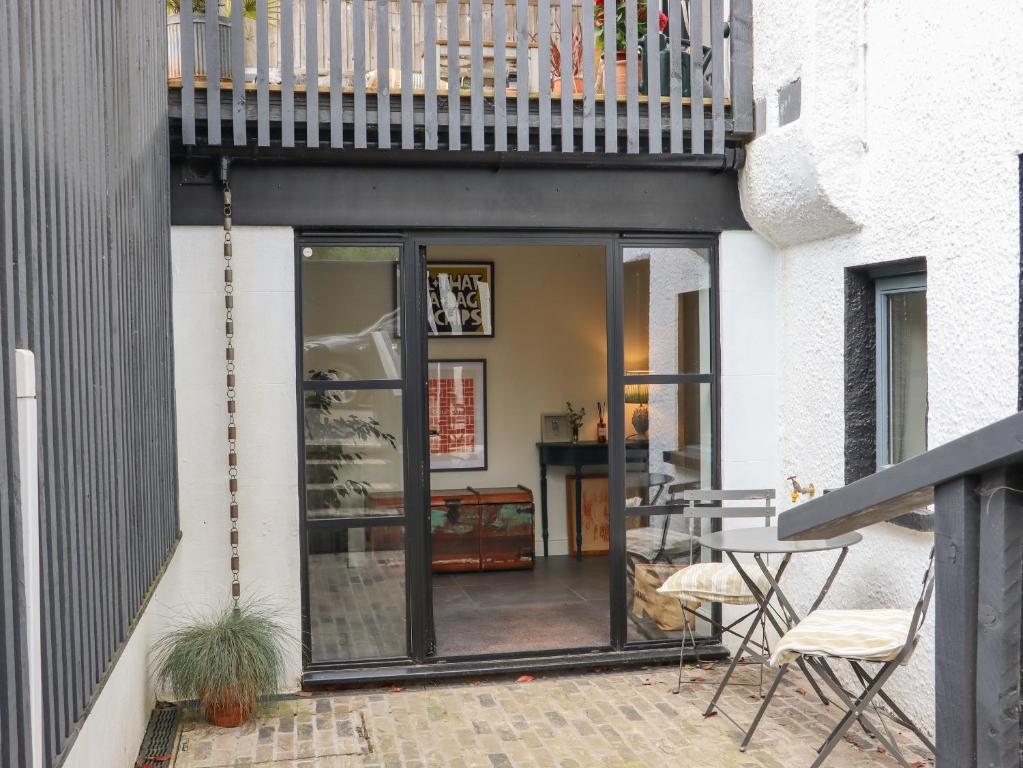 a patio with glass doors and a balcony at Artists Hideaway in Battle