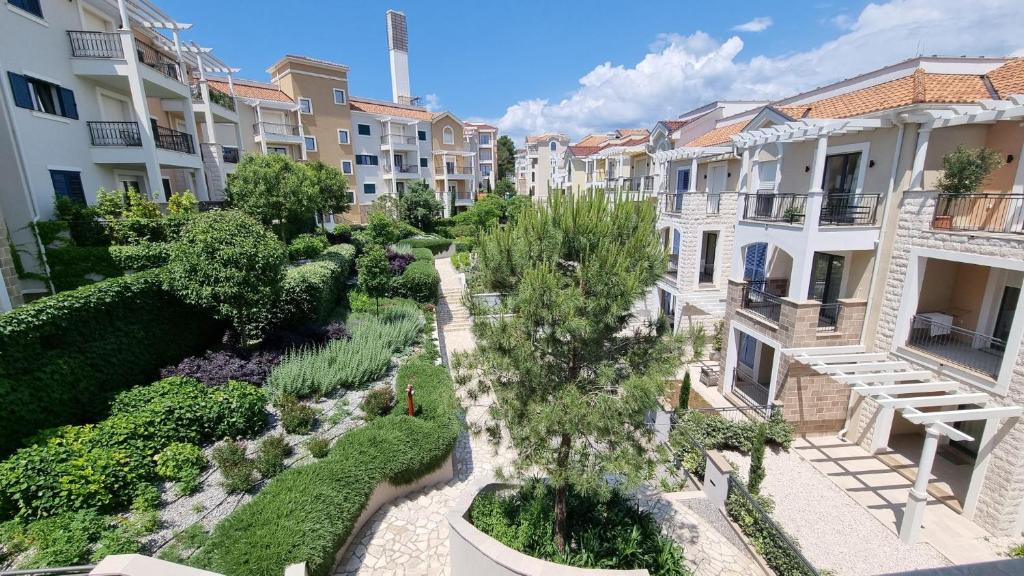 an apartment complex with a garden and buildings at Lustica Lux in Tivat