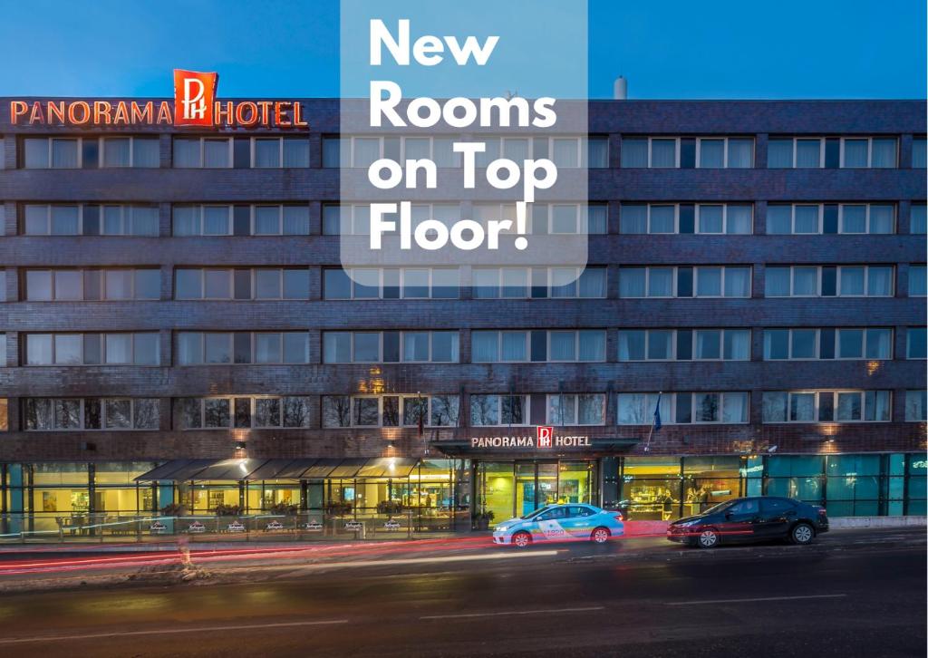 a building with two cars parked in front of it at Hotel Panorama in Vilnius