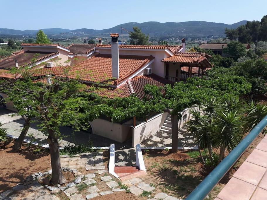 a view of a house with trees in front of it at Villa - Farmhouse in Oropos