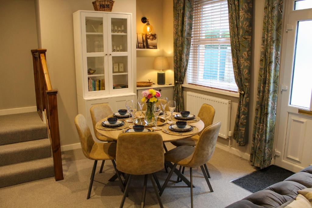 a dining table and chairs in a living room at No4 Chapel Row in Bakewell