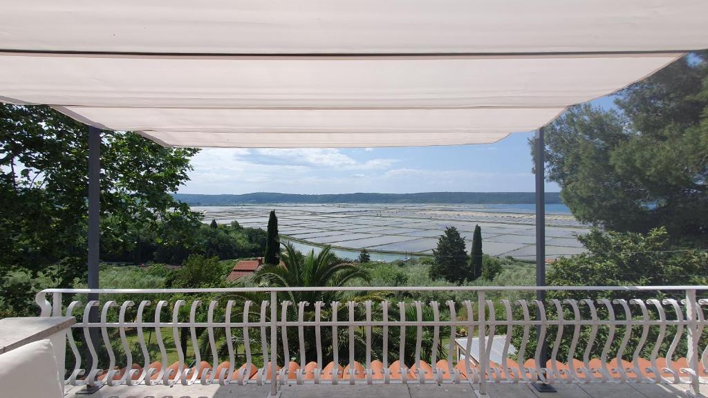d'une terrasse avec un auvent blanc et une vue sur l'océan. dans l'établissement Apartment Laurus, à Portorož
