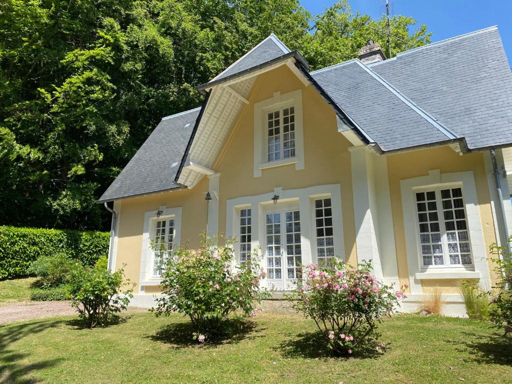 a small yellow house with a gray roof at La Maison du Gardien, Chateau de lAvenue in Pierrefitte-en-Auge