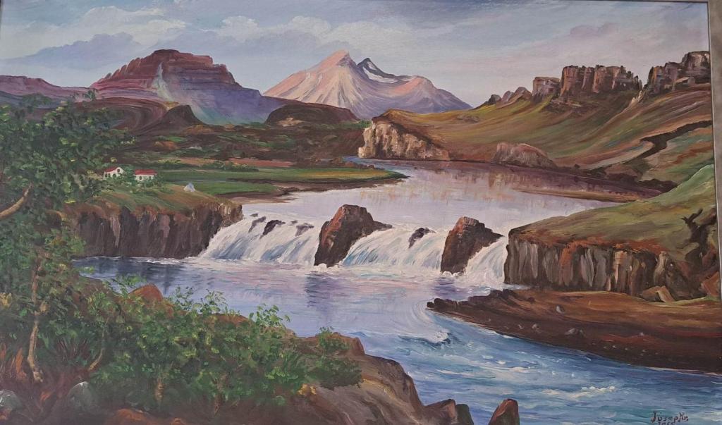 a painting of a river and mountains at Holiday Hostel in Reykjavík