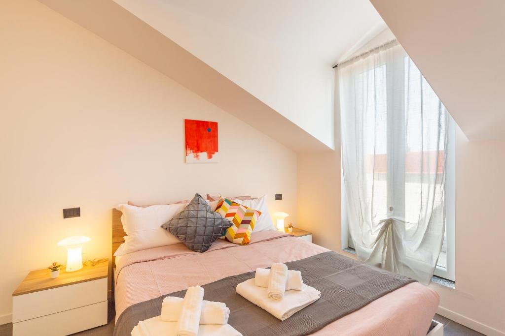 a bedroom with a bed with two towels on it at KHL APARTMENTS in Milan