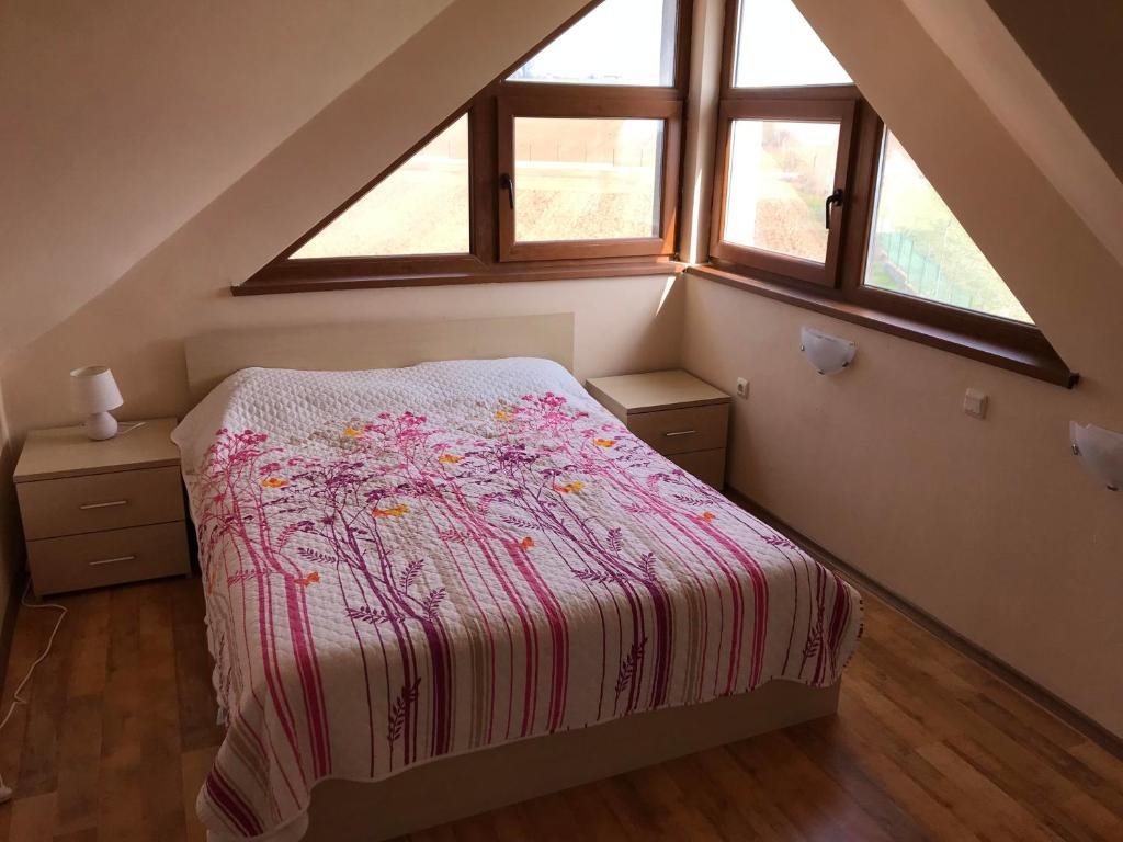 1 dormitorio con 1 cama y 2 ventanas en Loft Apartment in the fabulous Oasis Beach Resort, Kamchia en Dolen Bliznak