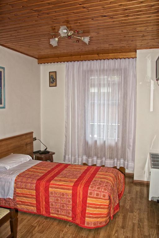 Postel nebo postele na pokoji v ubytování Albergo Ristorante Iris