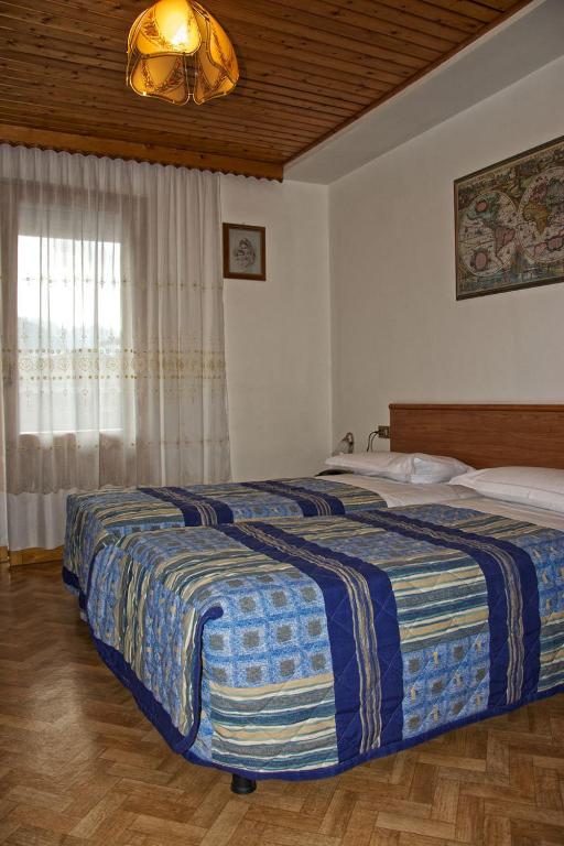 Postel nebo postele na pokoji v ubytování Albergo Ristorante Iris