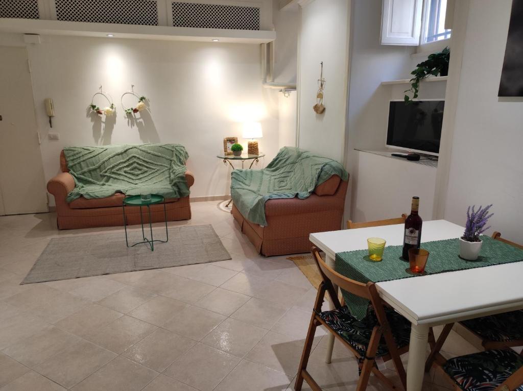 a living room with two couches and a tv at Home in Trastevere Testaccio in Rome