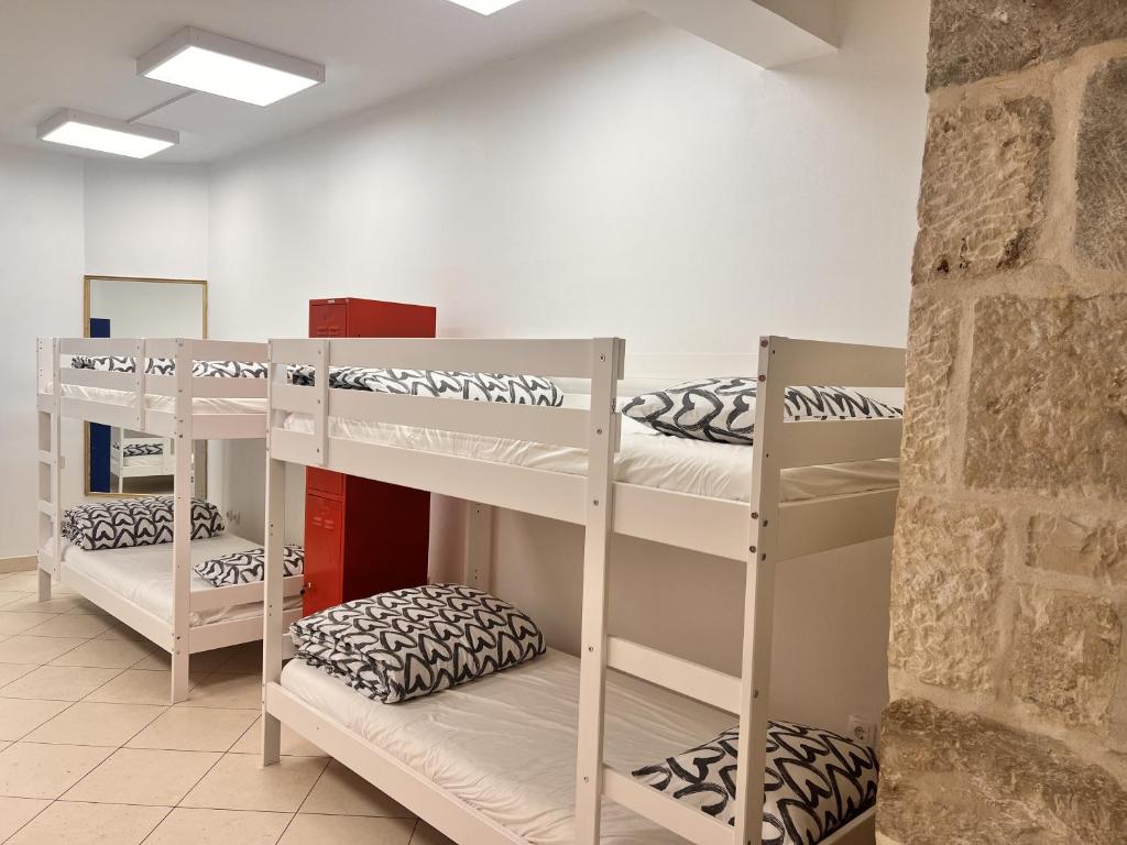 a room with three bunk beds in it at Split It Hostel in Split