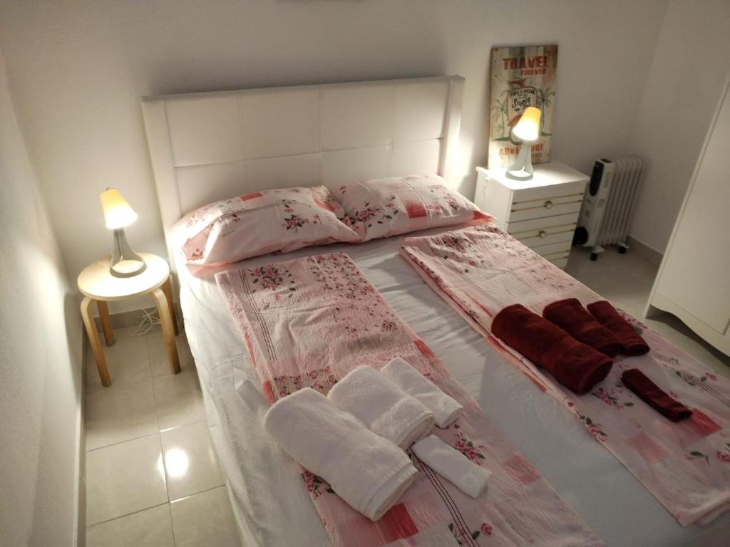 a bedroom with a bed with towels on it at Casa da laranjeira in Montargil