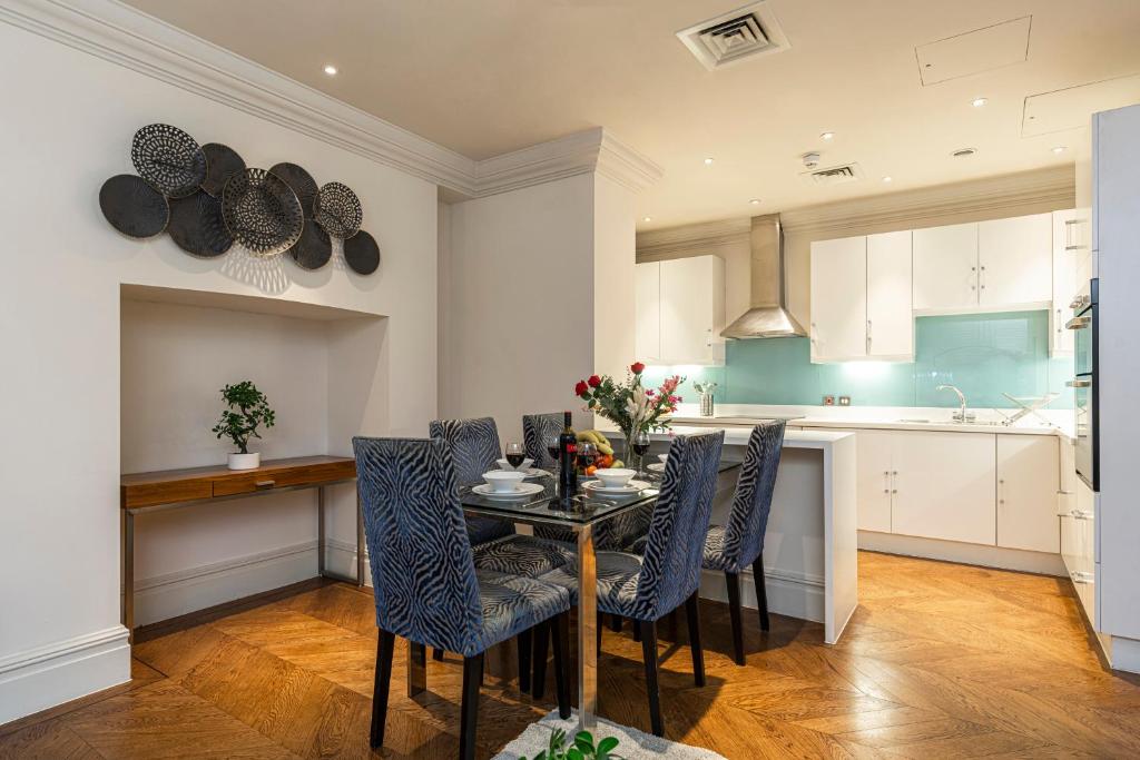 a dining room with a table and chairs in a kitchen at Grosvenor Mayfair in London