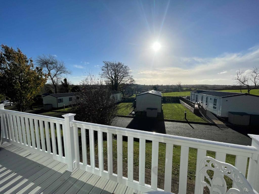 a balcony with a white fence and a yard at Stonewood Premium - 2 bedroom VS04 in Tenby