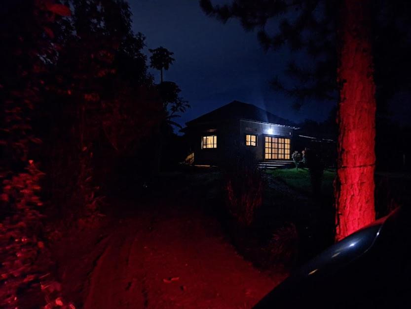 una casa iluminada por la noche con luces en Hfarms Guest House, en Wakiso