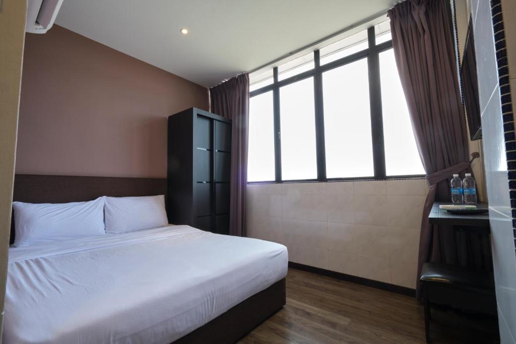 Postel nebo postele na pokoji v ubytování SkyCity Motel Pulau Ketam