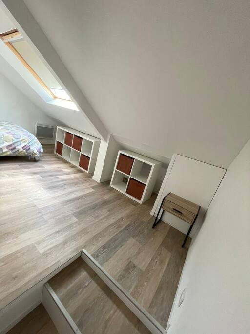 a attic room with a bed and a table at MILO - Appartement T2 Lanester in Lanester