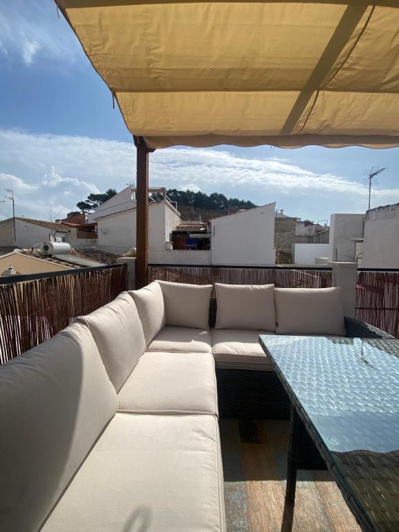 a white couch and a table on a roof at Casa Castillo. in Denia