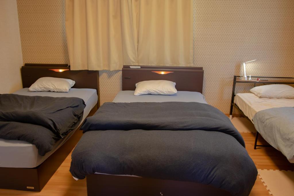 Postel nebo postele na pokoji v ubytování GuestHouse　YOU&I