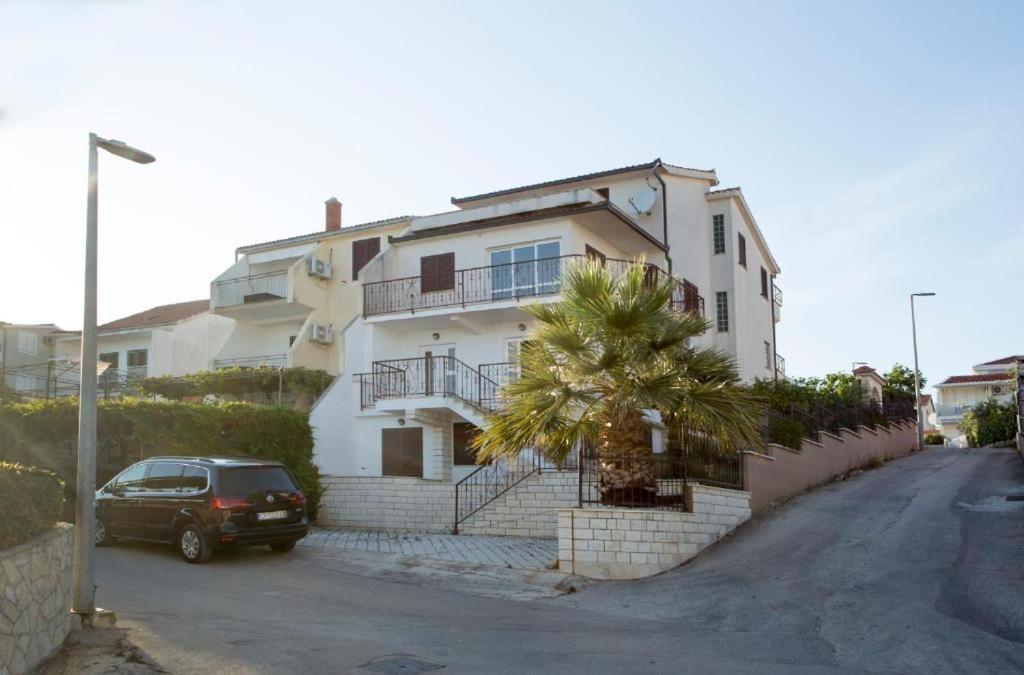 a car parked in front of a white house at Serenity near the sea in Okrug Gornji
