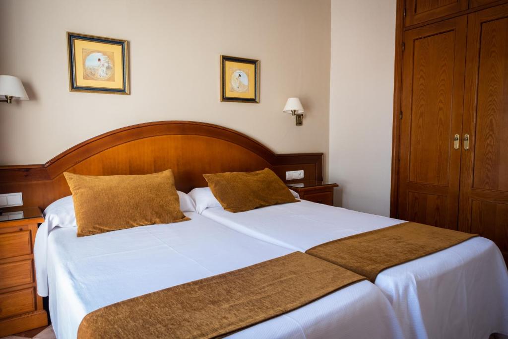 Posteľ alebo postele v izbe v ubytovaní Hostal Cabo Roche