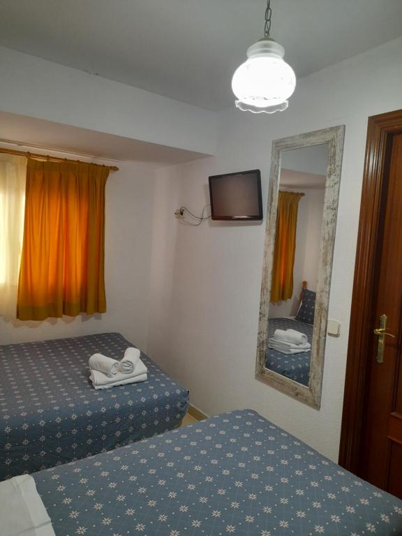 Postel nebo postele na pokoji v ubytování Hostal Salomé