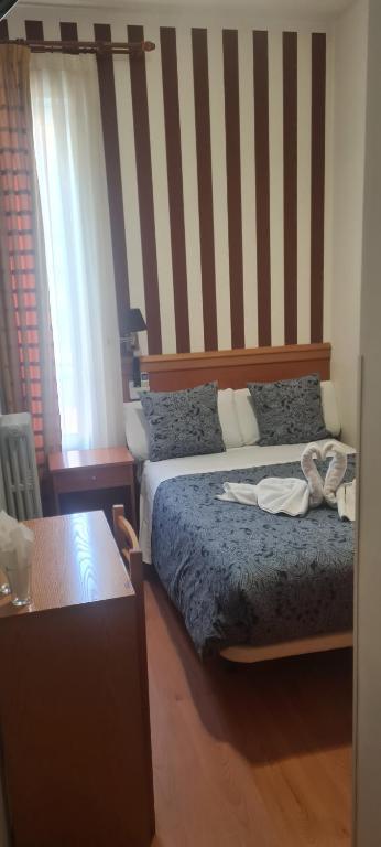 Postel nebo postele na pokoji v ubytování Hostal Salomé
