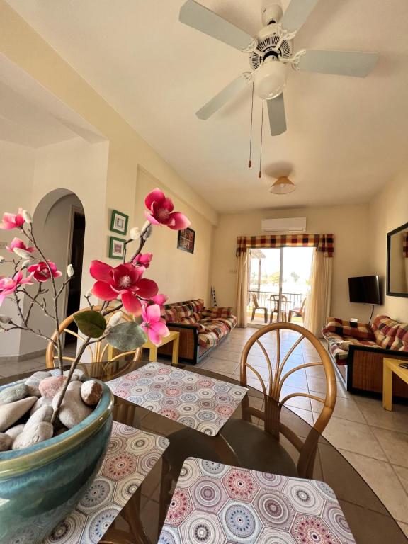 a living room with a couch and a ceiling fan at Sirena Kings in Paphos