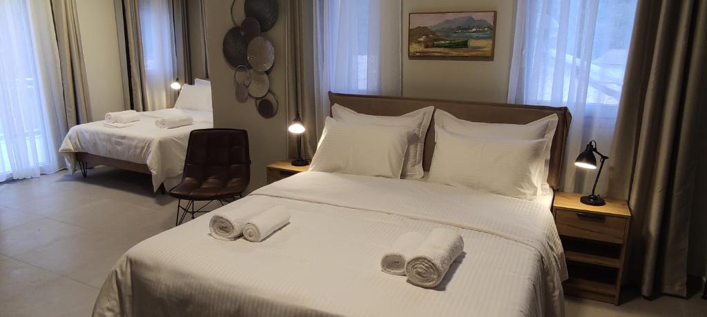 a hotel room with a bed with towels on it at Cruzeto in Syvota