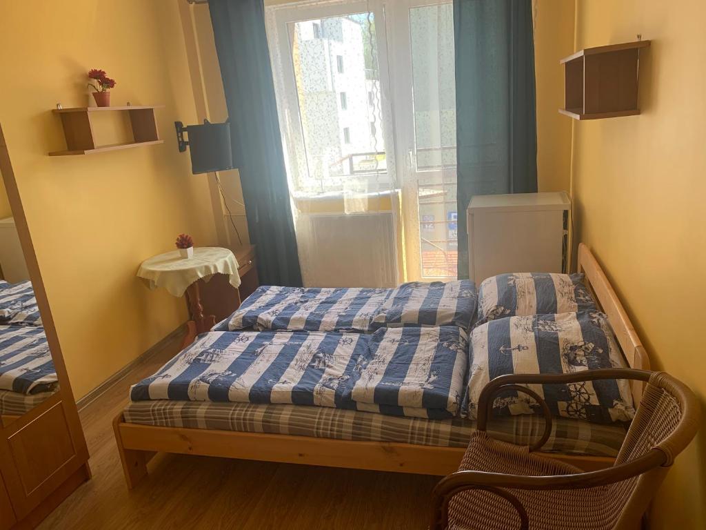 a small bedroom with a bed and a window at GWIAZDA MORZA in Hel