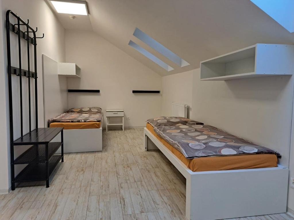 a bedroom with two beds and a staircase at Work&Home Stupava in Stupava