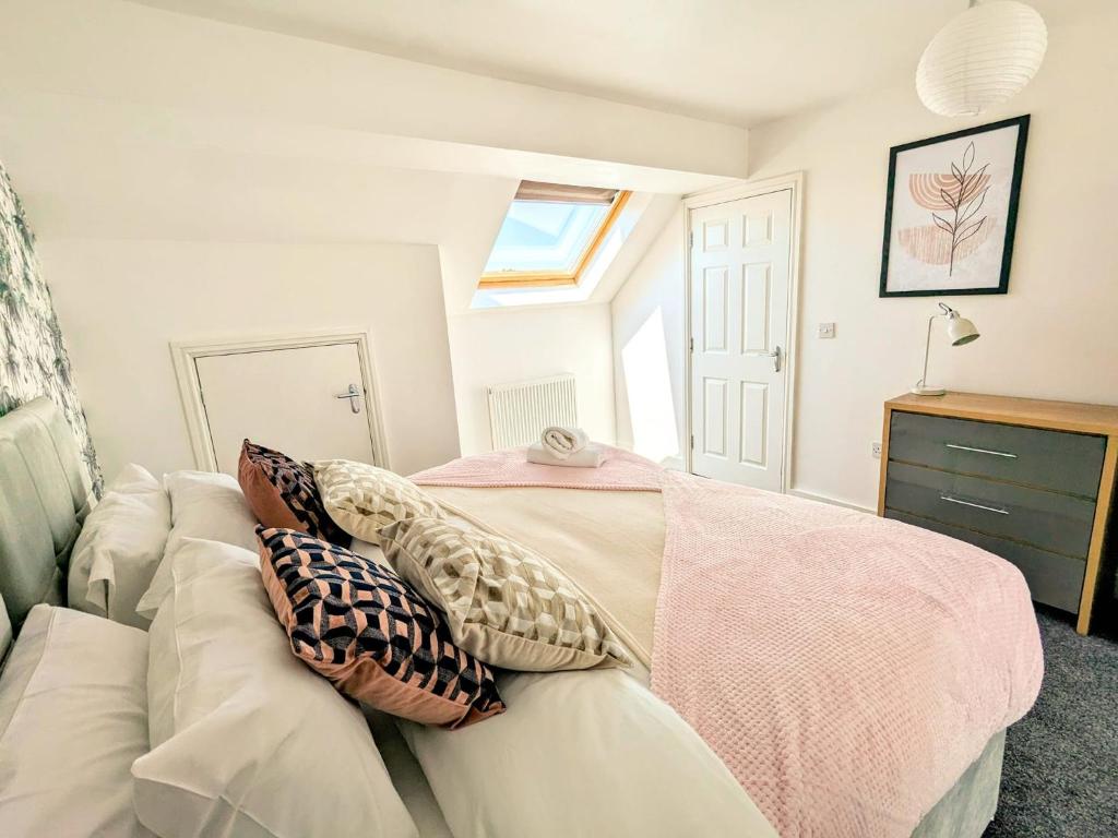 a living room with a white couch with pillows on it at Latchford Mews in Warrington